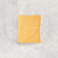 Yellow moss knit cotton throw blanket on a gray textured background.