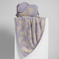 Heart patterned soft travel blanket and pouch with a matching lavender eye mask on a white background.