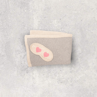 Compact grey and beige ravel blanket with a sleep mask-set. Soft organic cotton airplane blanket with a fun pink hearts design.