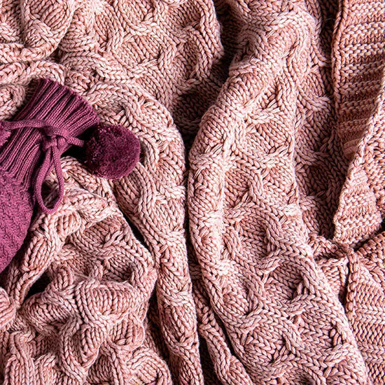 Pink Lemonade Washed Curvy Cotton Knit Throw Blanket in pink, shown in a close-up with chunky curved knit texture.