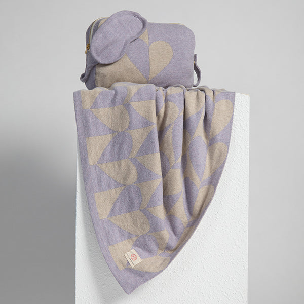 Heart patterned soft travel blanket and pouch with a matching lavender eye mask on a white background.