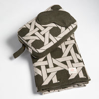 Soft olive green organic cotton travel blanket with a geometric design, paired with a mask and bag. Ideal for airplane travel.