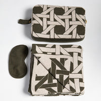 Zippered compact travel organiser in olive green, containing the Riti organic cotton travel blanket and matching eye mask set.